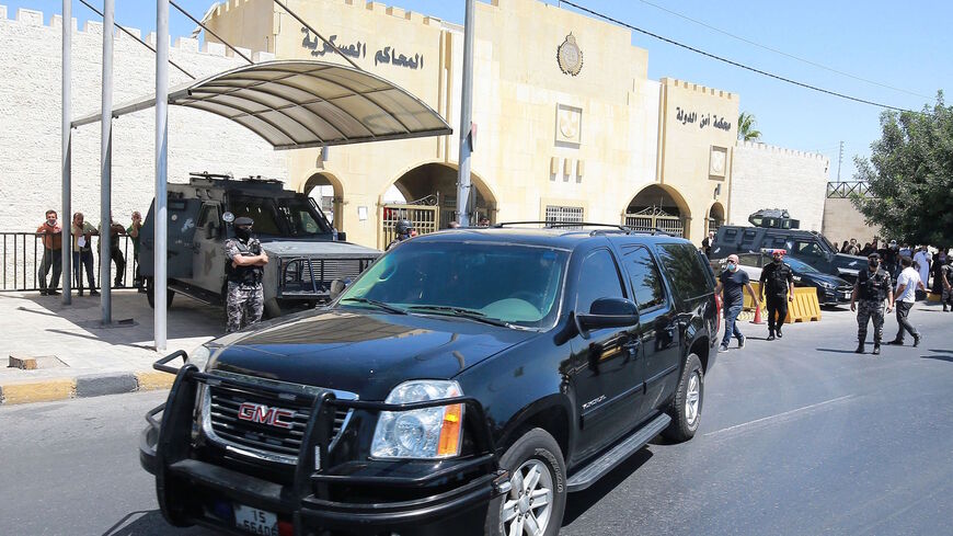 A car transporting former Jordanian royal adviser Bassem Awadallah leaves the State Security Court after a verdict was announced in his trial alongside another official, accused of helping Prince Hamzah try to overthrow his half-brother King Abdullah II, in the capital Amman on July 12, 2021.