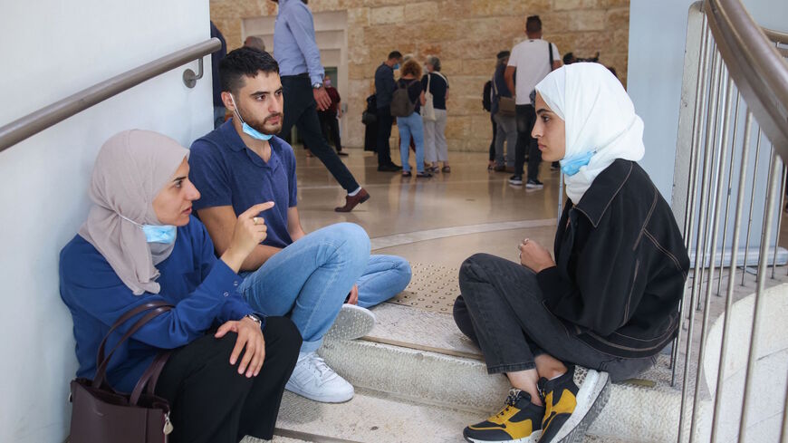 Palestinian sibling activists Mona (R) and Mohammed (C) al-Kurd wait at the Israeli Supreme Court in Jerusalem as it convenes to rule on Palestinian evictions in east Jerusalem, on Aug. 2, 2021. 
