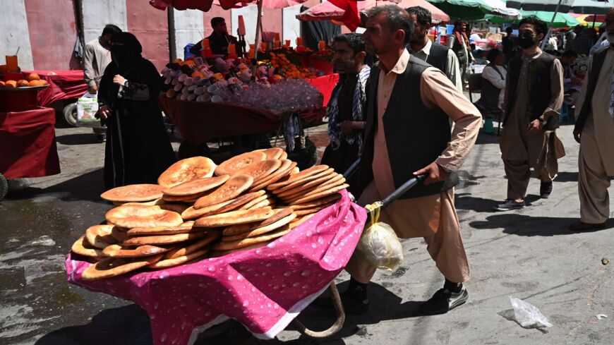 A man carries bread on a wheelbarrow at a market in downtown Kabul on Aug. 28, 2021, following the Taliban's stunning military takeover of Afghanistan.