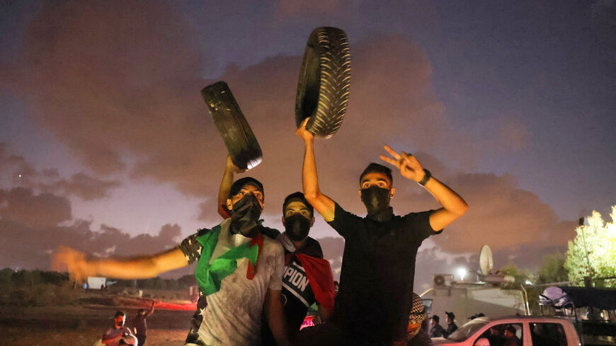 Palestinians gather on Aug. 30, 2021 during a protest along the border fence with Israel, east of Gaza City in the central Gaza Strip, demanding an end to Israel's blockade and the right of Palestinians to return to lands they fled or were expelled from when the Jewish state was founded. 