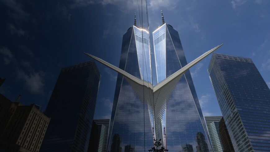 The One World Trade Center "Freedom Tower" and "The Oculus" are reflected in a window in New York, on Sept. 8, 2021. 