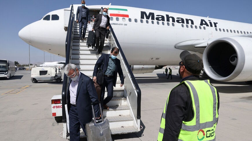 Passengers get off from a privately owned Iranian airline Mahan Air flight at the airport in Kabul on Sept. 15, 2021.