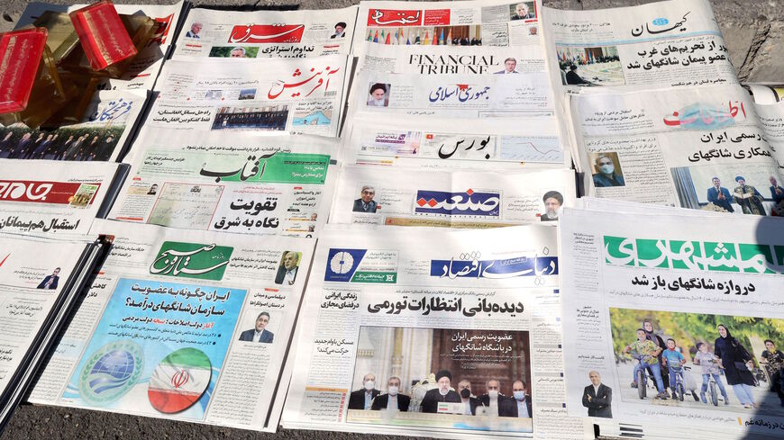 A picture shows daily newspapers on sale at a kiosk in the capital Tehran, on Sept. 18, 2021. Conservative and reformist newspapers showed rare unity in welcoming results of a conference yesterday in Dushanbe, Tajikistan, where members of the Shanghai Cooperation Organisation endorsed Iran's future membership in the bloc.