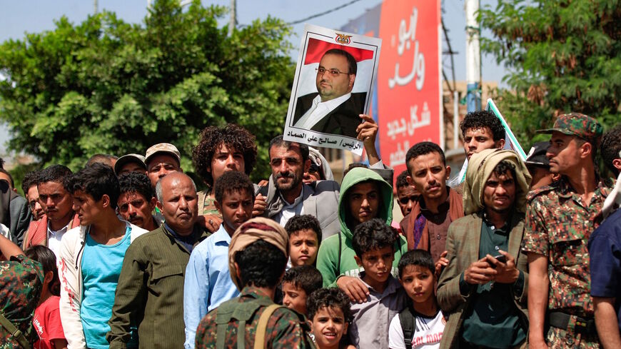 Yemeni men and children watch the execution of nine men, convicted of involvement in the assassination of Huthi political leader Saleh al-Sammad three years ago, at a public square in the Yemeni capital Sanaa, on Sept. 18, 2021. 