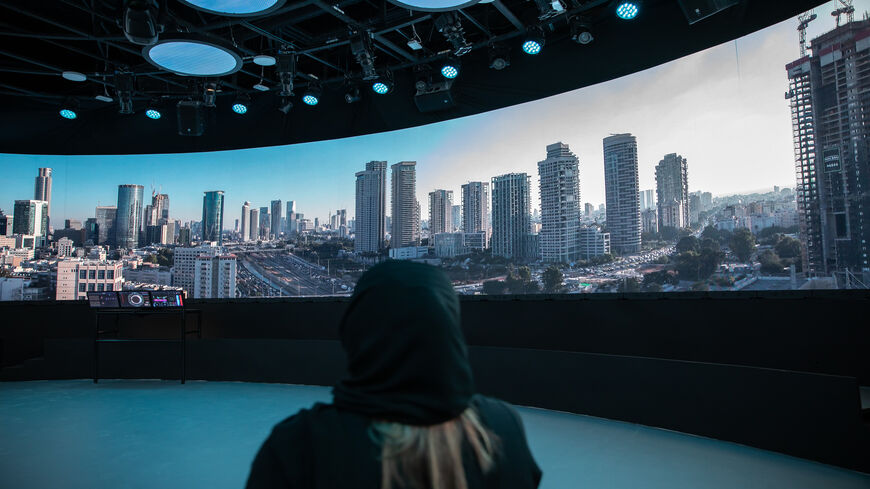 An Emirate woman watches the 360-degree video display at the Israeli Pavilion at Expo 2020 Dubai, United Arab Emirates, Sept. 27, 2021.