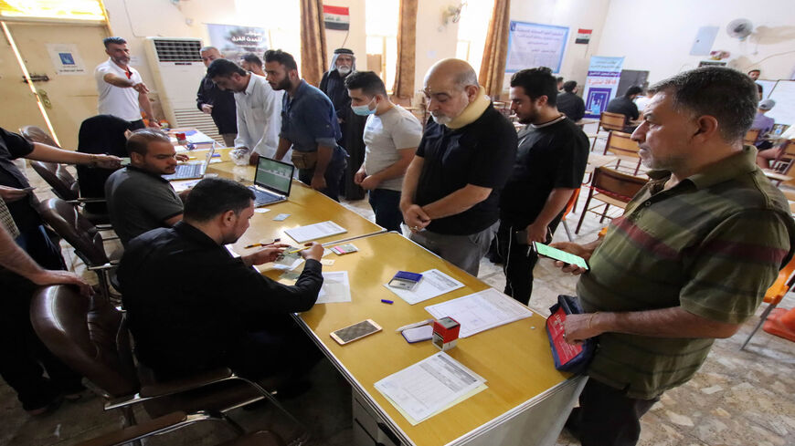 Iraqis register to obtain their voting cards ahead of the upcoming parliamentary elections, Najaf, Iraq, Sept. 29, 2021.