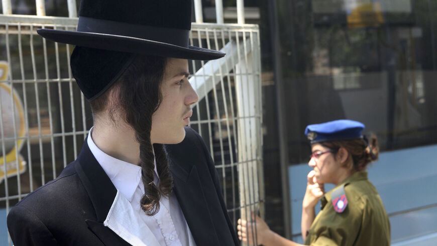 A religious Jewish yeshiva (seminary) student stands outside the local army draft office May 11, 2006 at Tel Hashomer near Tel Aviv in central Israel. 