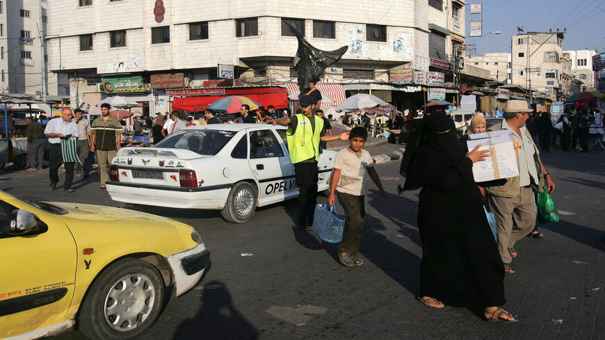 A volunteer member of Hamas directs traffic in a street in Gaza City, Gaza Strip, Aug. 21, 2007.