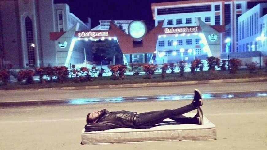 A student sleeps in front of Gumushane University in Gumushane, Turkey, Sept. 20, 2021.