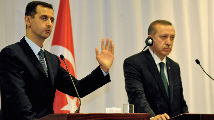 Turkish Prime Minister Recep Tayyip Erdogan (R) listens to Syria's President Bashar al-Assad delivering a speech during their press conference at Ciragan Palace on June 7, 2010 in Istanbul. 