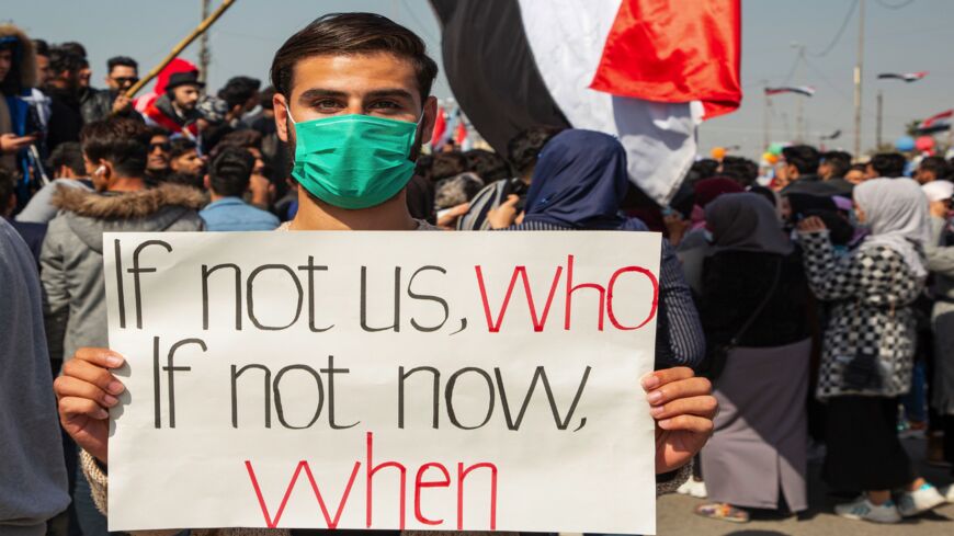 An Iraqi demonstrator holds a placard during an anti-government demonstration by Basra University students in the southern city of Basra, on Feb. 11, 2020.
