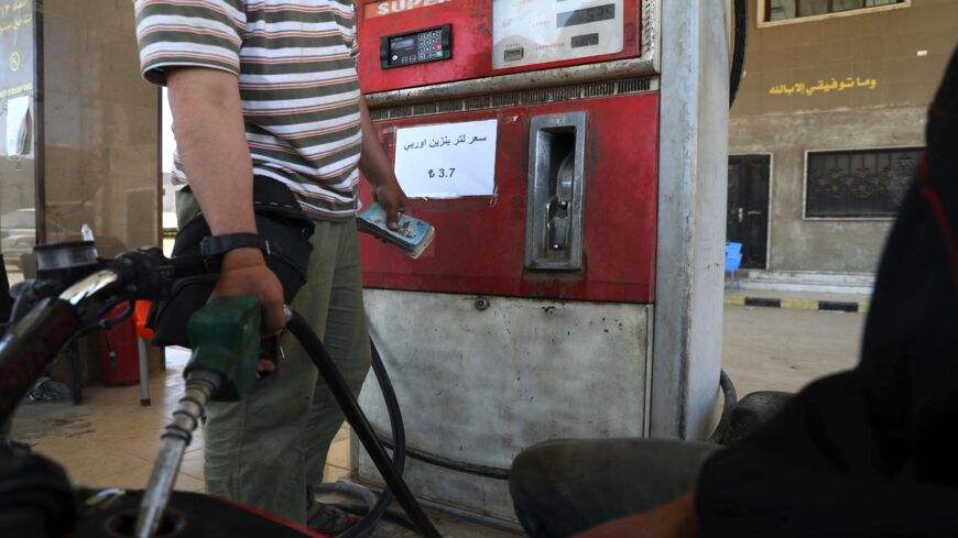 Gasoline prices are displayed in Turkish lira at a gas station in the town of Sarmada in Syria's northwestern Idlib province, on June 15, 2020. 