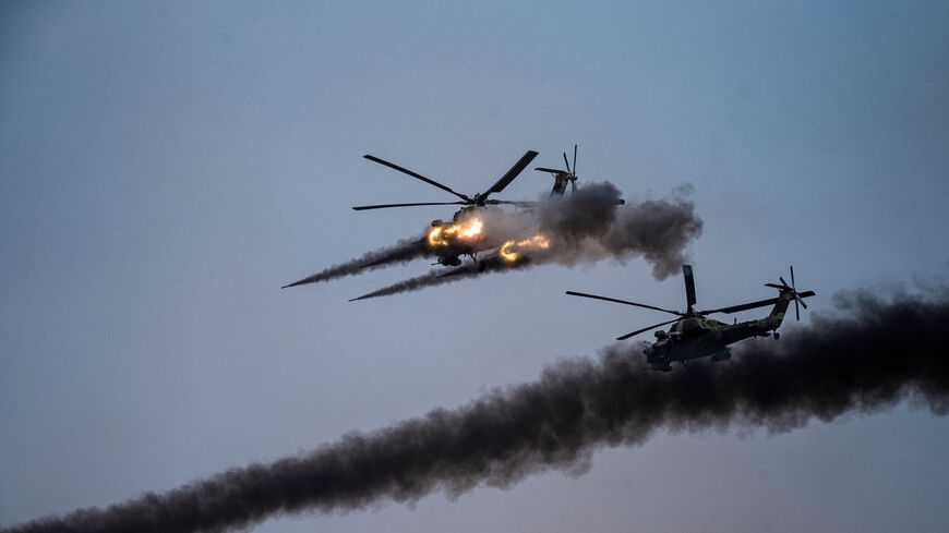 Russian attack helicopters launch rockets during military exercises at the Kapustin Yar range in Astrakhan region, Southern Russia on Sept. 25, 2020 during the "Caucasus-2020" military drills gathering China, Iran, Pakistan and Myanmar troops, along with ex-Soviet Armenia, Azerbaijan and Belarus. 