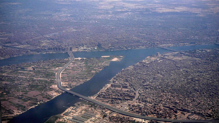 This picture shows an aerial view of the "Tahya Masr" (Long Live Egypt) overpass crossing the Nile River island of Warraq (L) on the northern outskirts of Cairo from the district of Rod al-Farag in Cairo (top) into the district of Imbaba in Cairo's twin city of Giza (bottom) to connect with the ring-road highway circling greater Cairo, Egypt, May 14, 2021.