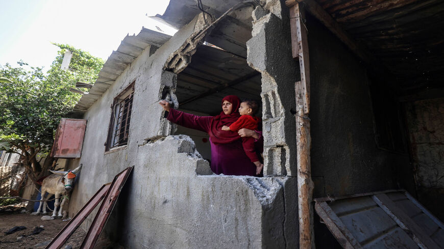 A Palestinian woman inspects the damage at her house following Israeli bombing in Beit Hanoun in the northern Gaza Strip, Aug. 29, 2021.