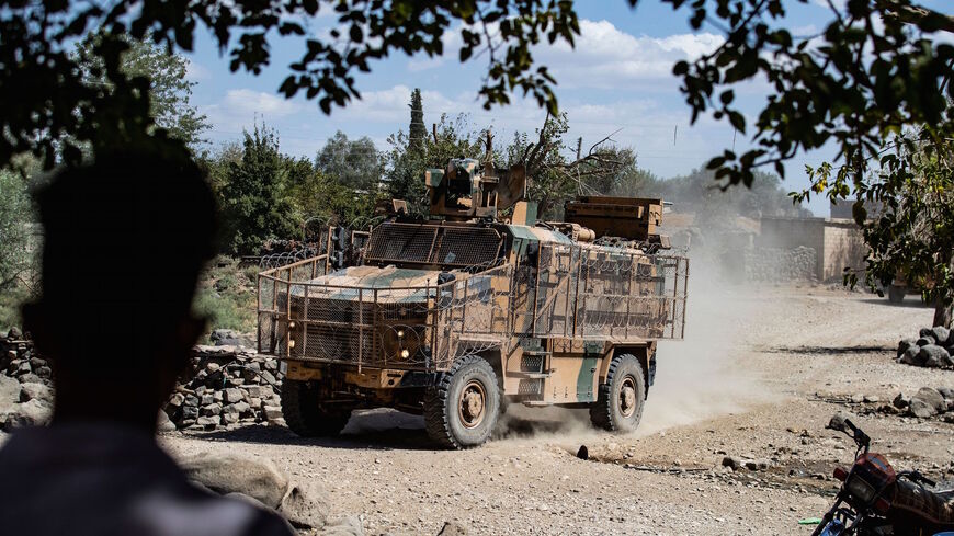 Turkish and Russian military vehicles patrol in the countryside of Rumaylan (Rmeilan) in Syria's northeastern Hasakeh province near the Turkish border, on Sept. 16, 2021.