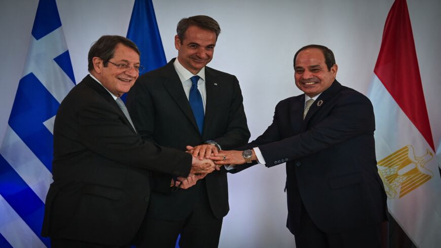 Greece's Prime Minister Kyriakos Mitsotakis (C) welcomes Egypt's President Abdel Fattah al-Sisi (R) and Cypriot President Nicos Anastasiades (L).