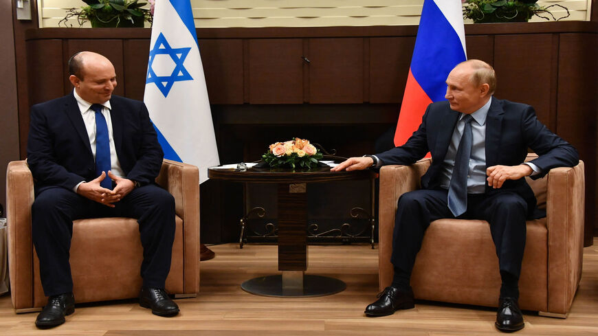 Russian President Vladimir Putin (R) speaks with Israeli Prime Minister Naftali Bennett during their meeting, in Sochi, Russia, Oct. 22 2021.