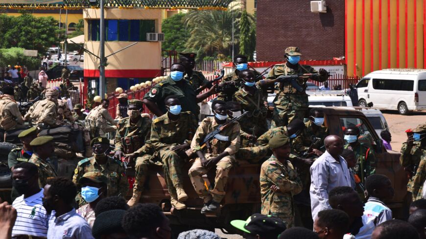 Sudanese security forces keep watch as they protect a military hospital and government offices during protests against a military coup.