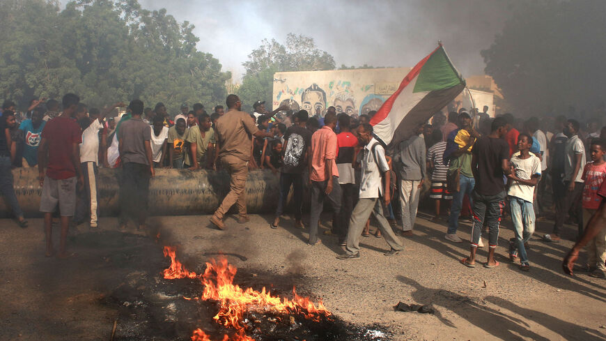 Sudanese men protest against a military coup that overthrew the transition to civilian rule, on Oct. 25, 2021 in the al-Shajara district in southern Khartoum. 