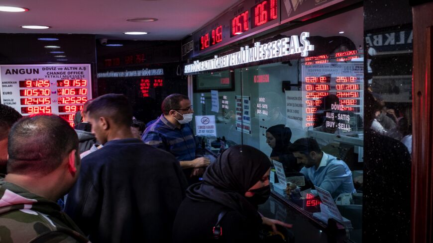 People line up to exchange money at a currency exchange office on Oct. 14, 2021, in Istanbul, Turkey.