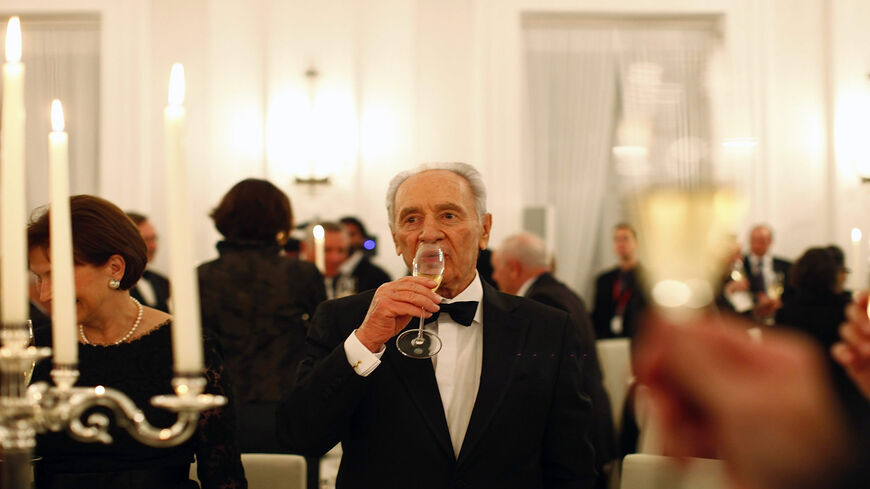 Israeli President Shimon Peres drinks at a gala dinner given by German President Horst Koehler in honor of the Israeli president, Berlin, Germany, Jan. 26, 2010 .
