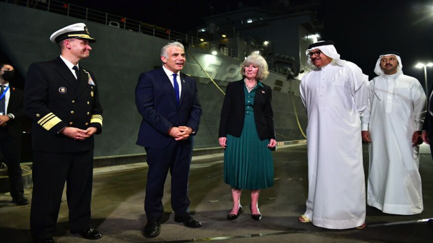 Foreign Minister Yair Lapid, second from left, visits the USS Pearl Harbor in Bahrain, Sept. 30, 2021.