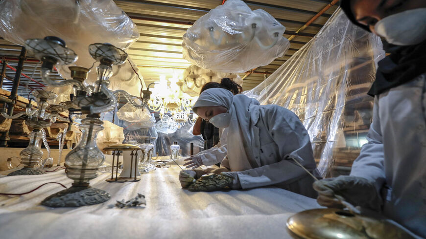 Laborers clean chandeliers during the restoration of Mohammed Ali Shubra Palace, Cairo, Egypt, Sept. 12, 2019.