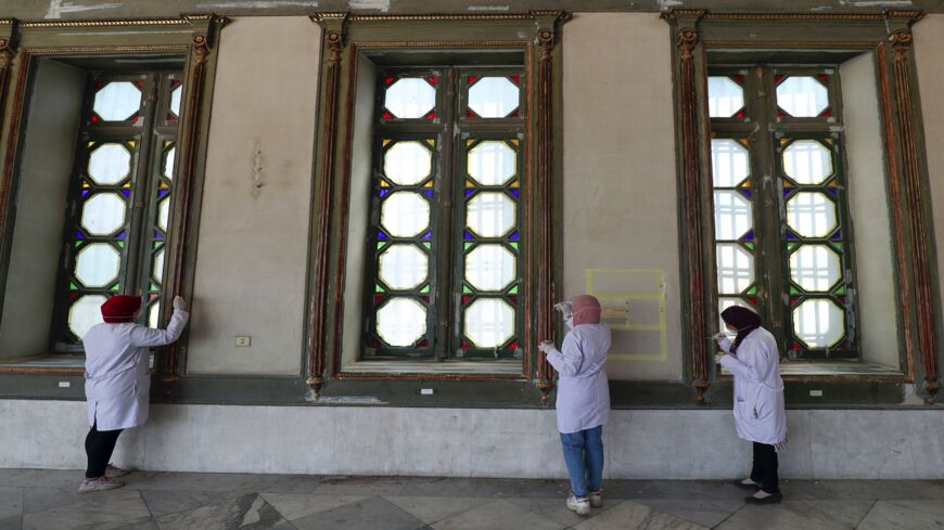 Workers paint window frames during the restoration of Mohammad Ali Shubra Palace in the Egyptian capital, Cairo, on Sept. 12, 2019. 