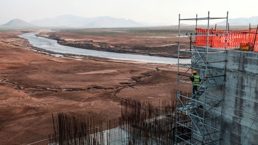 A worker goes down a construction ladder at the Grand Ethiopian Renaissance Dam near Guba in Ethiopia, on Dec. 26, 2019.