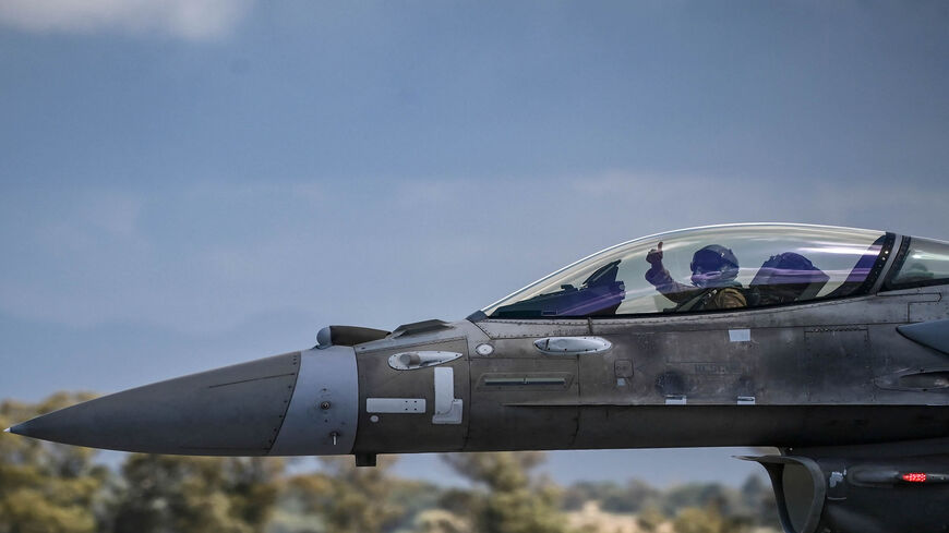 A United Arab Emirates Air Force F-16 pilot gives a thumb up before taking off from the military airport of Andravida, southern Greece, April 19, 2021.