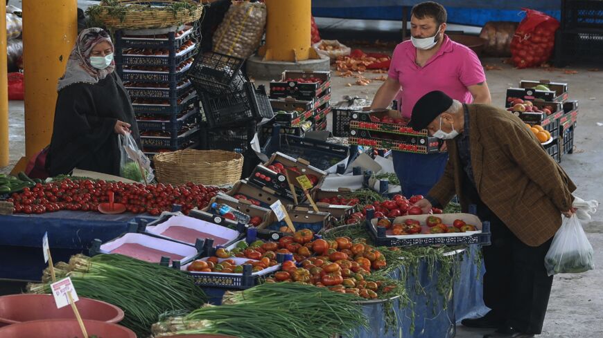 People shop at an open-air market in Ankara.