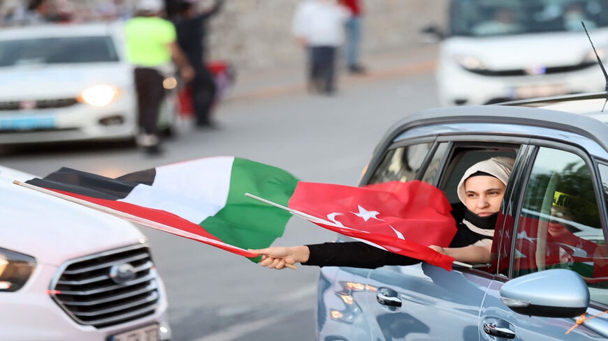 A pro-Palestinian supporter holds a Palestinian flag during a protest to condemn the ongoing Israeli airstrikes on the Gaza Strip, in Ankara, Turkey, May 18, 2021.