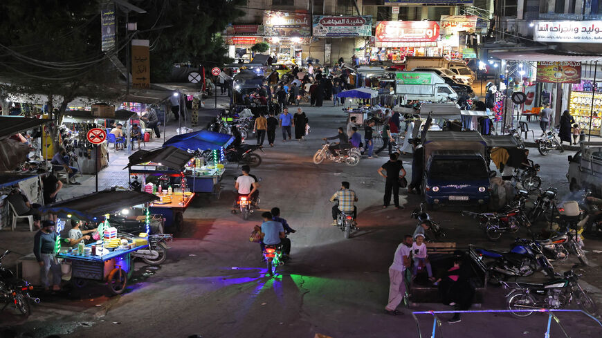 This picture shows a view of nightlife ahead of the Muslim holiday of Eid al-Adha at the Clock Square, Idlib, Syria, July 18, 2021.