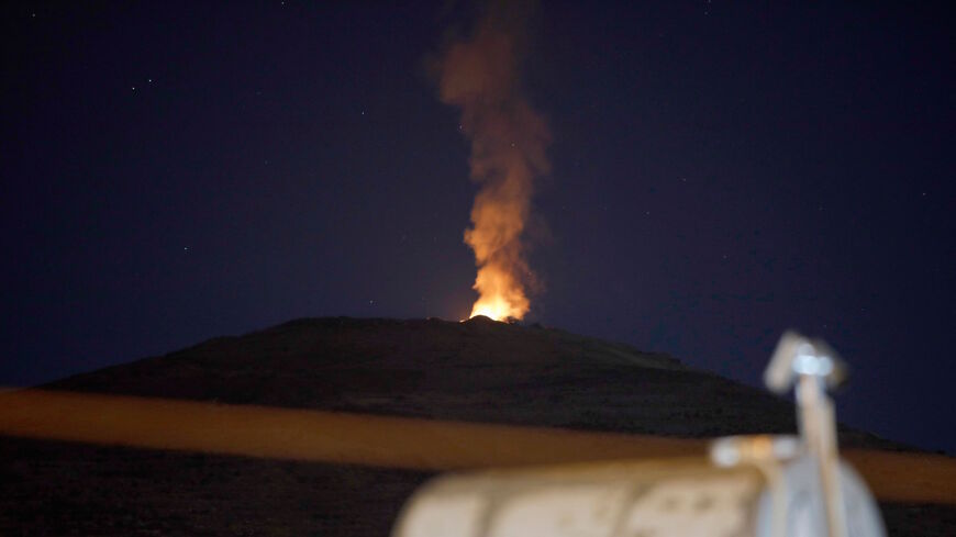 A picture taken on Aug. 17, 2021, from the Druze village of Majdal Shams in the Israeli-annexed Golan Heights shows a fire burning in Syrian territory after a reported Israeli strike.