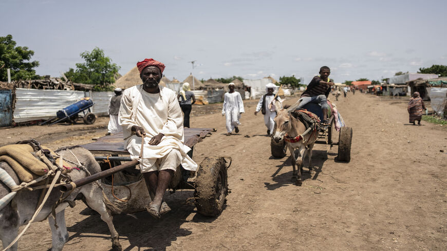 An Eritrean man sits on his donkey drawn cart in the market of Shagarab refugee camp, Shagarab, Sudan, Aug. 15, 2021.