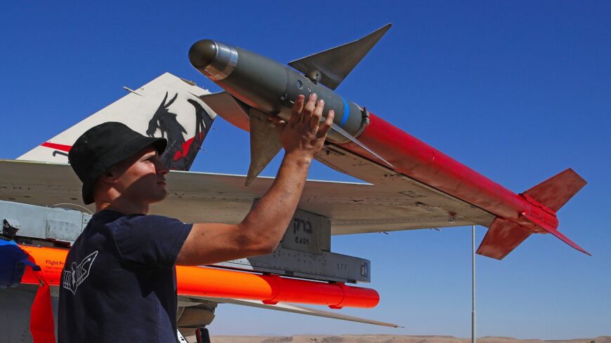 An Israeli air force mechanic inspects an F-16 fighter during the Blue Flag multinational air defense exercise.