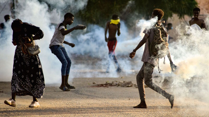 Sudanese youths confront security forces amidst tear gas fired by them to disperse protesters in the capital Khartoum, on Oct. 27, 2021, amid ongoing demonstrations against a military takeover that has sparked widespread international condemnation.