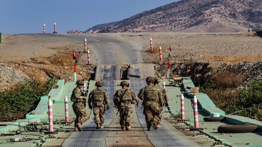 US soldiers patrol an area near Syria's northeastern Semalka border crossing with Iraq's Kurdish autonomous territory, on Nov. 1, 2021. 