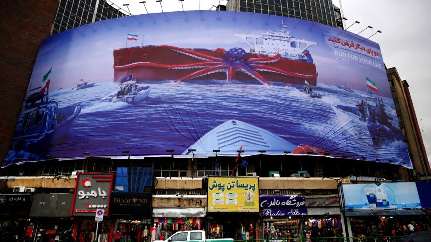 A billboard depicting Iranian Revolutionary Guard Corps navy units observing a US warship in the Gulf of Oman.