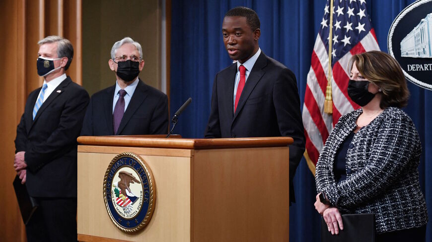 Deputy Secretary of the Treasury Wally Adeyemo speaks, alongside Attorney General Merrick Garland (2L), FBI Director Christopher Wray (L) and Deputy Attorney General Lisa Monaco (R) during a news conference over ransomware cyberattacks, at the Department of Justice, in Washington, DC on Nov. 8, 2021.  