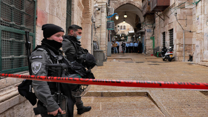 Israeli border guards stand guard behind a security perimeter at the scene of a shooting in the Old City of Jerusalem, Nov. 21, 2021.