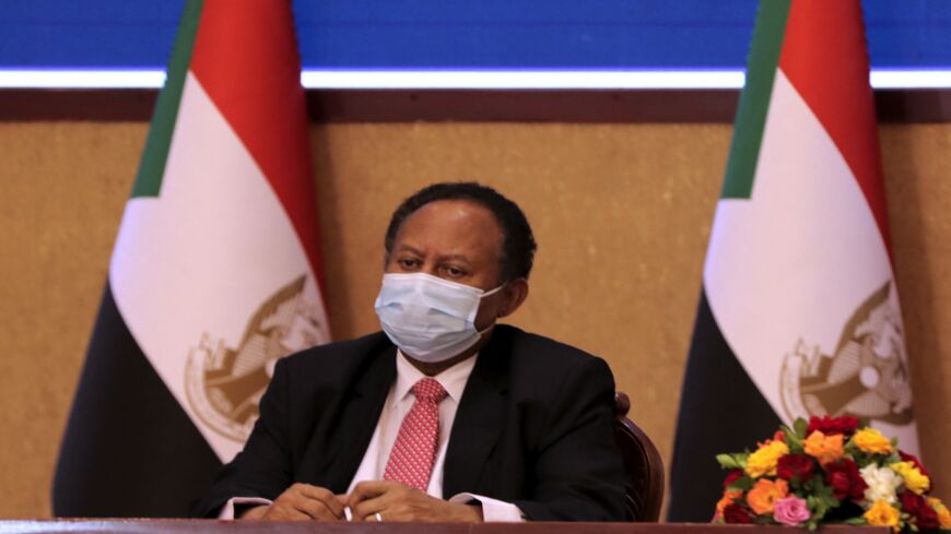 Sudan's Prime Minister Abdalla Hamdok looks on during a deal-signing ceremony with Abdel Fattah al-Burhan.