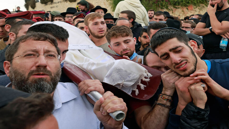 Mourners carry the body of Eliyahu David Kay during his funeral, a day after he was killed by a Palestinian gunman while on his way to the Western Wall in the Old City, Jerusalem, Nov. 22, 2021.