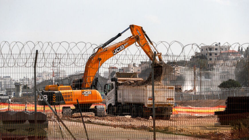 A picture shows machinery working on the tarmac of the former Atarot airport (Jerusalem International Airport), which has been closed to civilian traffic since the breakout of the second Palestinian intifada (uprising) in 2000, near the village of Qalandia between the West Bank city of Ramallah and Israel-annexed east Jerusalem on November 25, 2021.