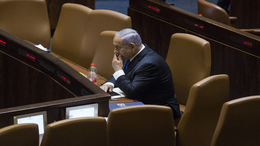 Israeli Prime Minister Benjamin Netanyahu sits in the Knesset before parliament votes to approve the new government, Jerusalem, June 13, 2021.