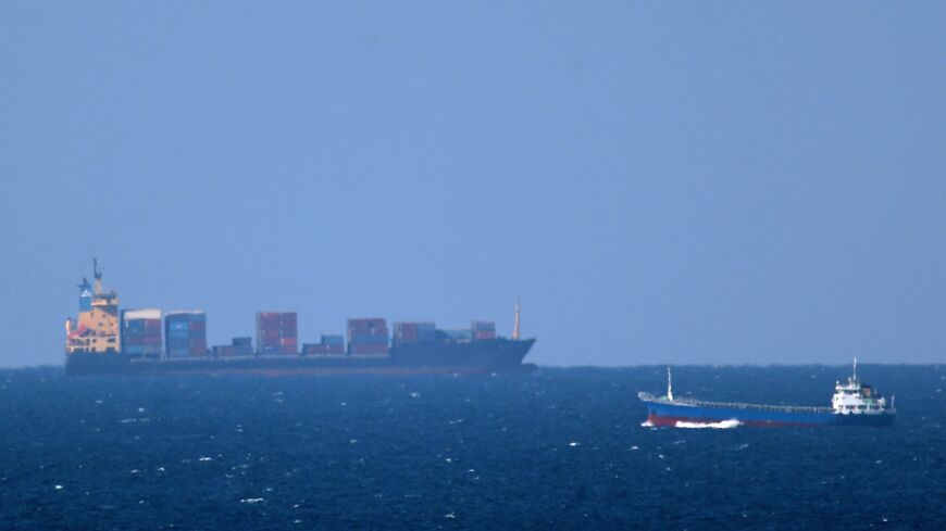 A cargo ship cruises towards the Strait of Hormuz off the shores of Khasab in Oman on Jan. 15, 2011.