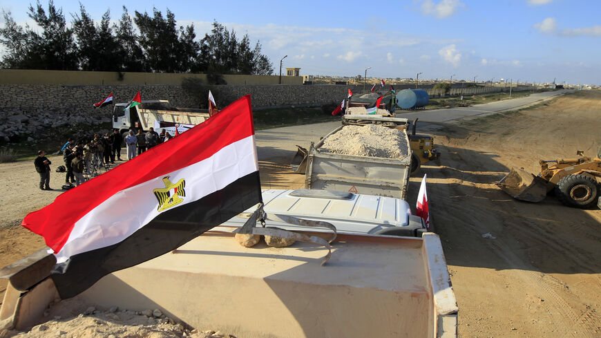 An Egyptian truck loaded with gravel enters through the Rafah border crossing, between Egypt and the Gaza Strip, as building material for the Qatari grant projects begin arriving, in the southern Gaza Strip, Dec. 29, 2012.