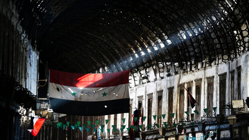 A general view shows the Syrian flag flying at the Hamidiya market in the old part of Damascus on Nov. 2, 2017.