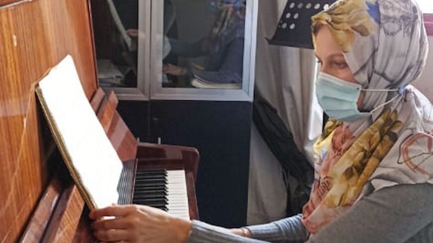 Elena Radwan, a dual Russian-Palestinian citizen from the Russian city of Voronezh, plays piano in Gaza.
